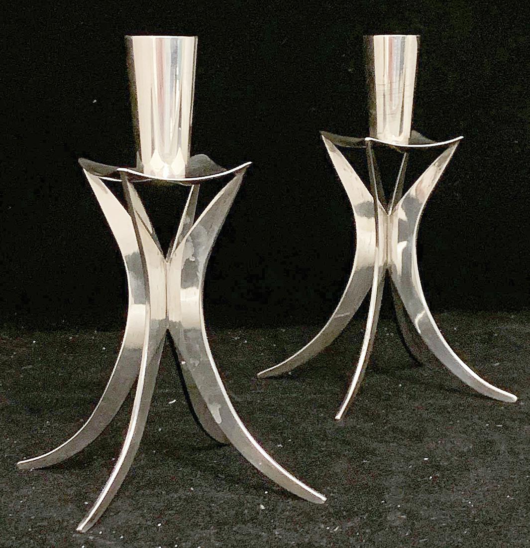 Pair Kurt Matzdorf Sterling Modernist Candlesticks: A pair of modernist sterling silver candlesticks by Kurt Matzdorf (German, 1922-2008), with tapering out-swept legs. Marked. 6-1/2in tall x 3-1/4in wide. Apx. 10 ozt total. Provenance: The Adelman Est