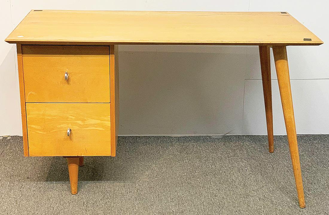 Paul McCobb Planner Group Desk: A Paul McCobb Planner Group desk with two drawers with ring pulls. 29in tall x 48in wide x 24in deep. Provenance: The Adelman Estate Collection, Hockessin DE.