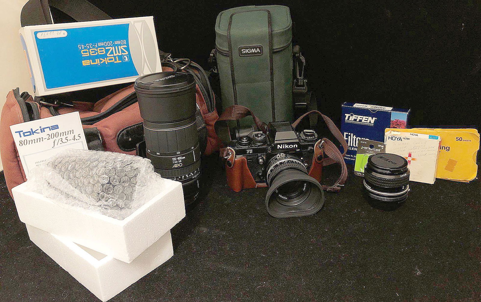 Nikon F3 Camera, Telephoto Lenses & Accessories: A lot of like-new camera equipment, including Nikon F3 film camera and four lenses: one Sigma 135mm-400mm F4.5-5.6 zoom lens that looks to have never been used, one Tokina 80mm-200mm F3.5-4.5 zoom len