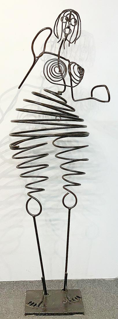Vincent Magni. Coiled Steel Kinetic Sculpture: Vincent Magni (French, 1963-). A coiled steel kinetic "Humanobile" sculpture of a female form. Cast signature on iron base. 67in tall x 18-1/2in wide x 12 in deep.