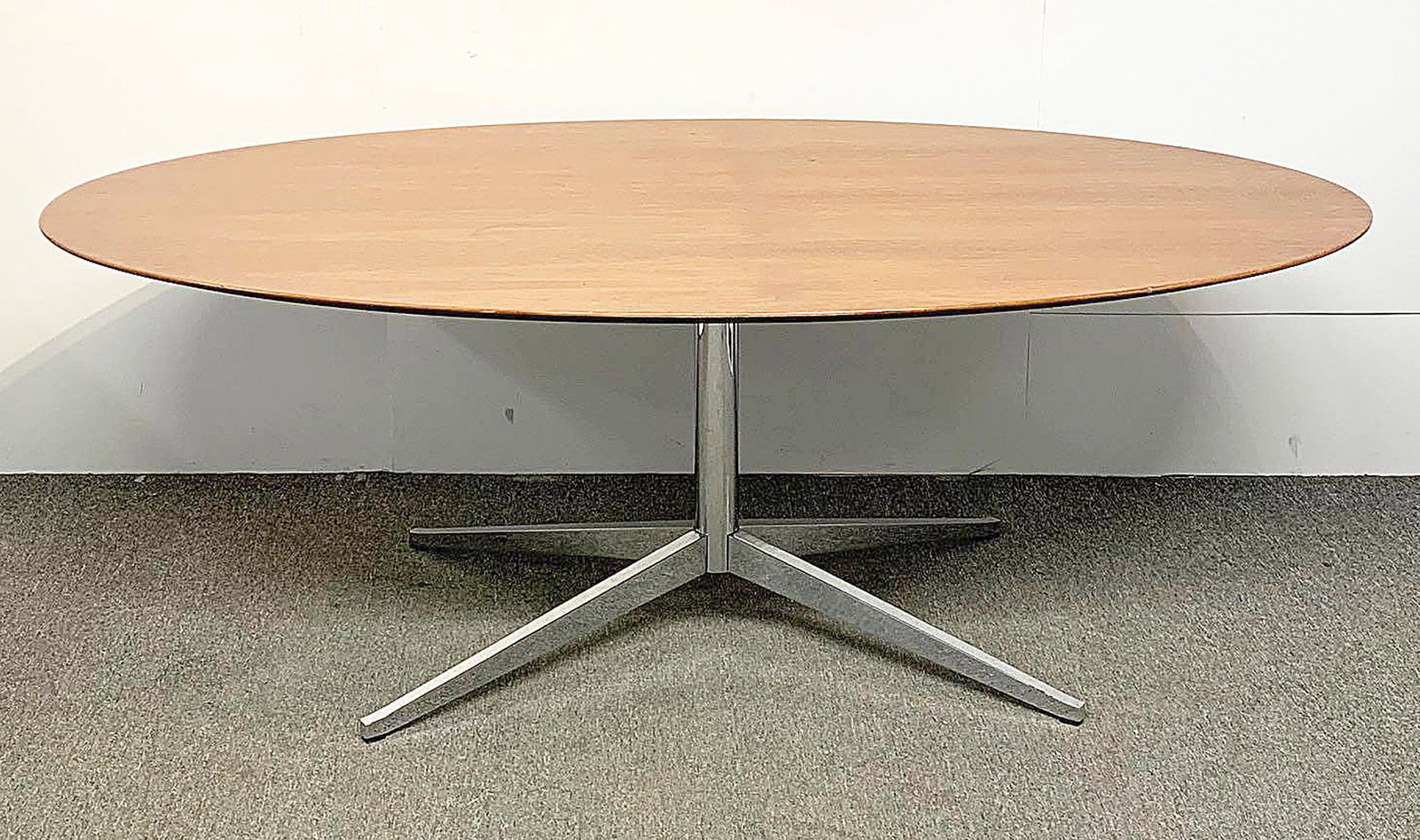 Florence Knoll Walnut and Chrome Dining Table: A Florence Knoll dining or conference table with an oval beveled walnut top on signature chrome pedestal base with X legs. Unmarked. 28in tall x 78in long x 48in wide.