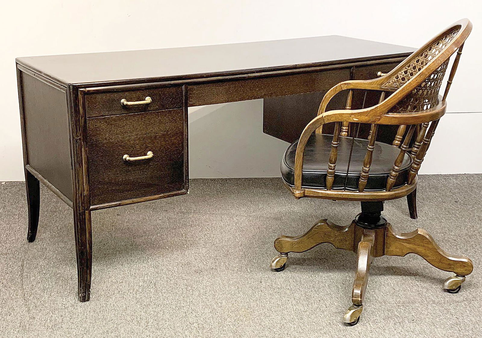 McGuire Faux Bamboo Desk: A McGuire faux bamboo decorator desk, model 237B, with an oak case with taupe finish and solid brass hardware, together with a caned associated desk chair and desk pad. Desk: 29in tall x 60in long x 2