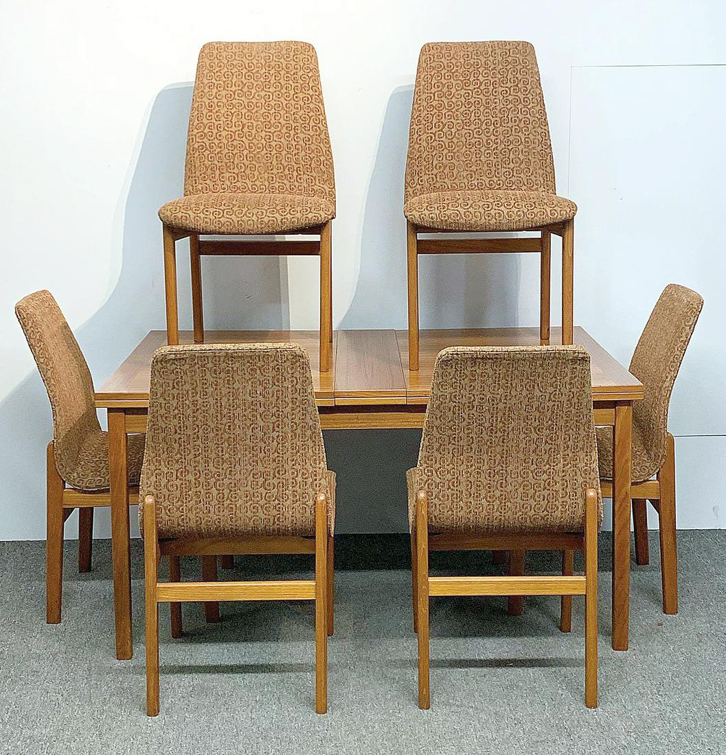 Scandinavian Modern Teak Dining Table and Chairs: A Scandinavian Modern teak dining room table and six chairs, comprised of a Skaraborgs Swedish flip-top extension dining table and six Spottrup Danish dining chairs. Table: 28in tall x 54-1/2in long x
