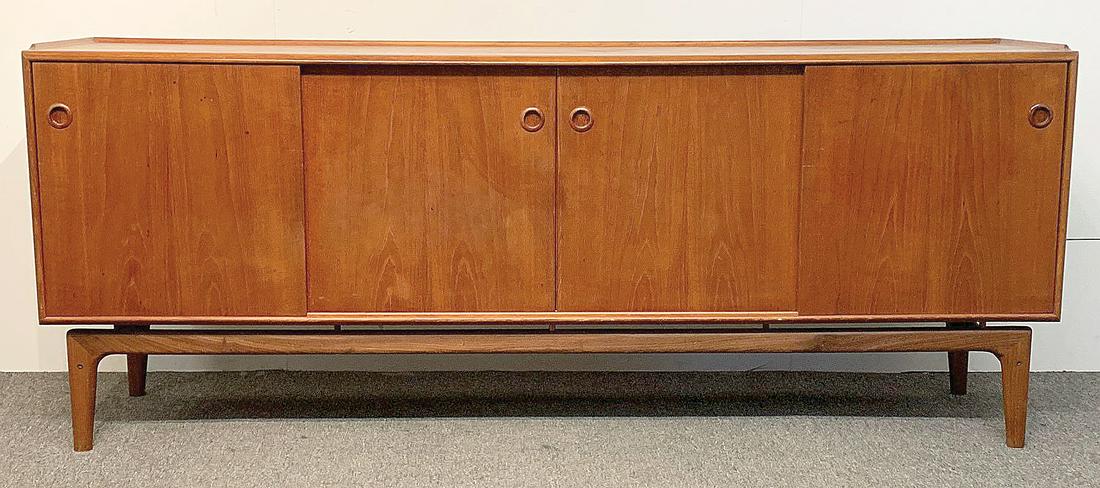 Arne Hovmand-Olsen Danish Teak Sideboard: Arne Hovmand-Olsen for Mogens Kold Danish modern teak sideboard/credenza with four sliding doors revealing a cabinet with drawers and open shelves, raised on an exposed frame with tapering legs. Medal