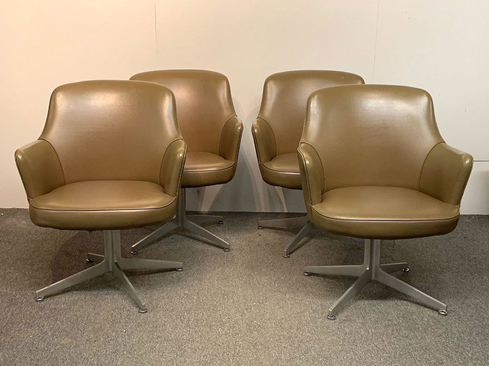 Four Ward Bennett Swivel Chairs: A set of four Ward Bennett for Lehigh Furniture swivel armchairs with I-beam bases. Upholstery labels on two chairs. Provenance: from the Herbert Bayer designed Container Corporation of American build
