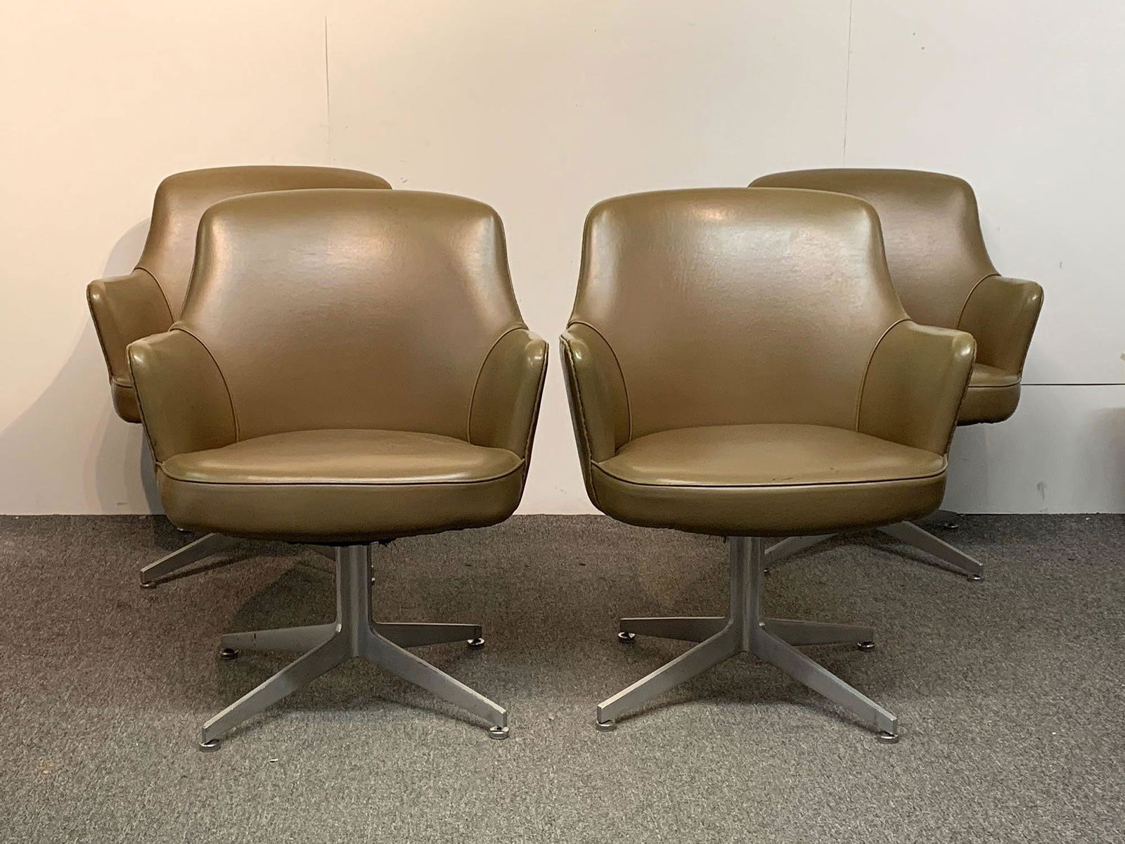 Four Ward Bennett Swivel Chairs: A set of four Ward Bennett for Lehigh Furniture swivel armchairs with I-beam bases. Upholstery labels on three chairs. Provenance: from the Herbert Bayer designed Container Corporation of American bui