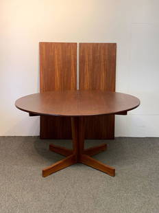 Arne Halvorsen Teak Dining Table: An Arne Halvorsen for J. Jacobsens teak dining table with a pedestal base that extends with two 19-1/2 in leaves. Norway, 1960s. Closed: 28in tall x 51in diameter.