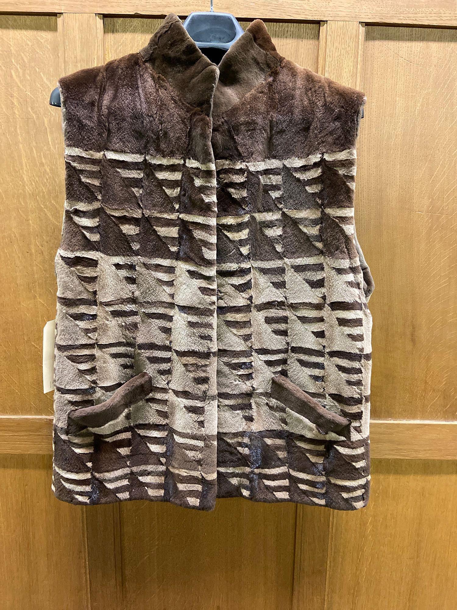 Mink Vest: Mink jacket with black lining, 3 hook and eye closures, 2 front pockets. 17in across chest; 29 in length from top of collar to hem. Provenance: C. Thomas and Alexandra Fuller Estate Collection of Will