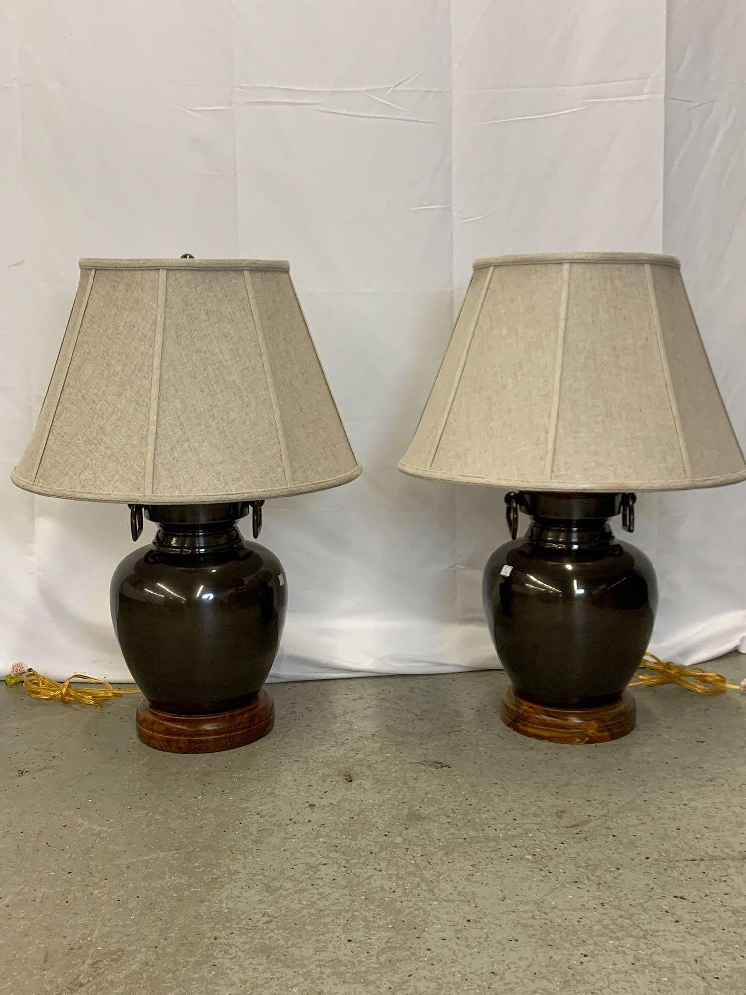 Pair Of Frederick Cooper Table Lamps: A pair of Frederick Cooper designer table lamps with polished bronze finished and wood bases and linen shades. Shades marked. 30 in tall.