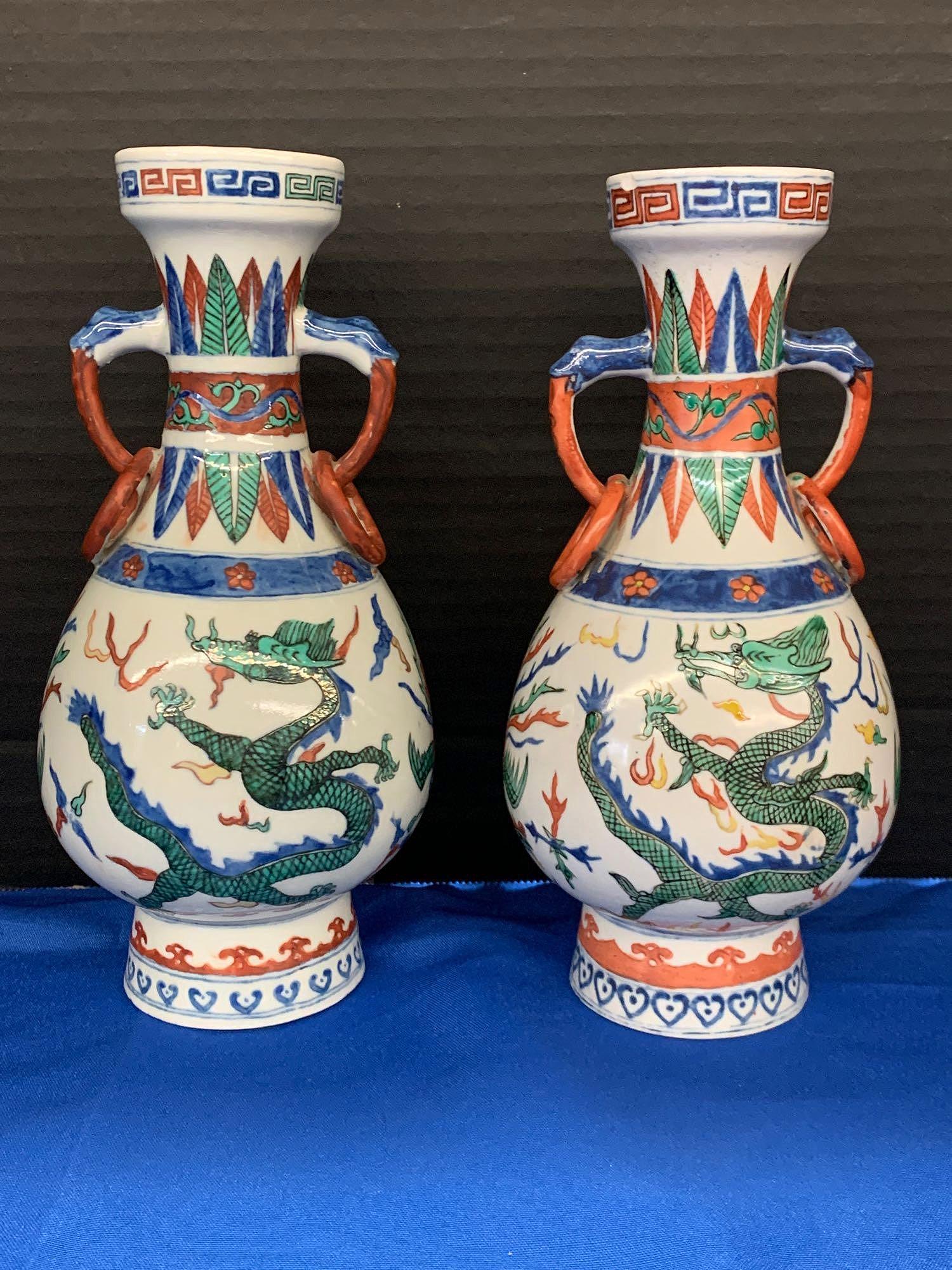 Pair of Chinese Porcelain Dragon Vases: A pair of Chinese porcelain dragon vases. Both signed along rim. 9 in tall.