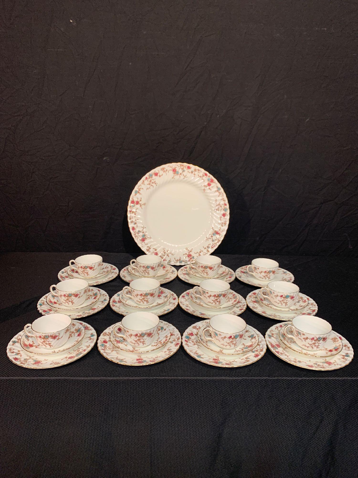 36-piece Minton Porcelain Dessert Service: A 36-piece Minton porcelain dessert service in the "Ancestral" pattern, consisting of 12 dessert plates (8in); 11 saucers (5.75in); 12 teacups; and a round salver (15in).