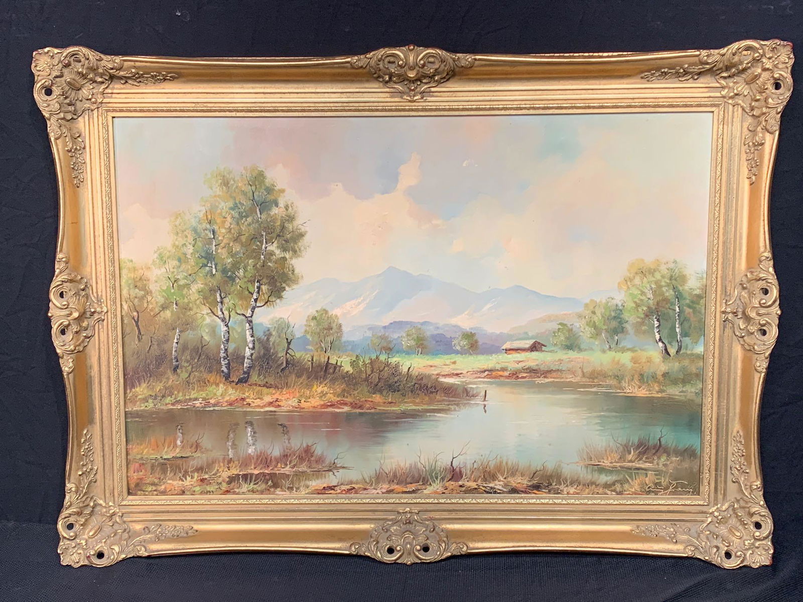 German School Oil/Canvas, Landscape: A German school oil on canvas mountainous landscape with river. Signed illegibly lower right; in a gilt frame. Canvas: 24in x 36in. Outside frame: 31in x 43in.