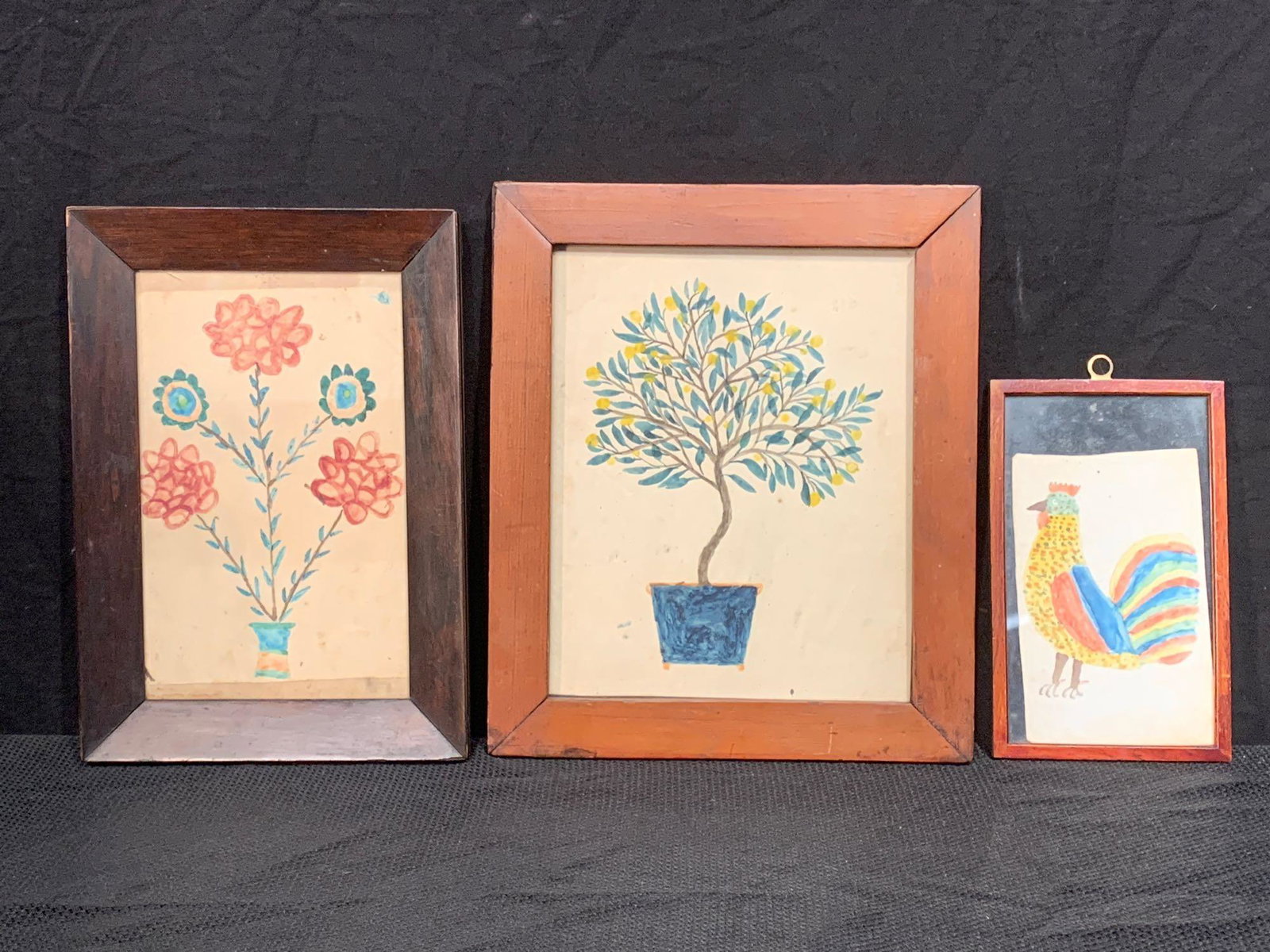 Three Ink & Watercolor Fraktur Drawings: Three 19th C. ink and watercolor fraktur drawings to include a lemon tree; a two-sided rooster and bird with deer; and a floral grouping in planter. Lemon tree frame opening: 9-1/4in x 7-1/4in.
