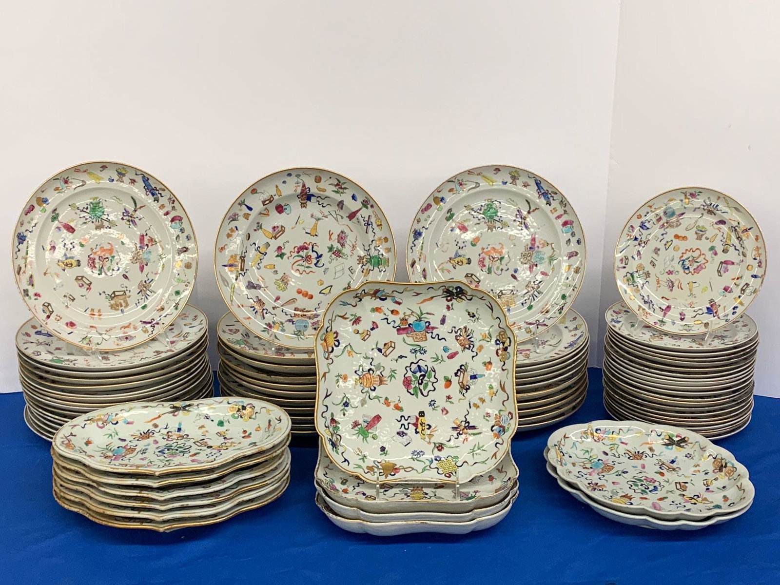 72-pieces Famille Rose Chinese Export Porcelain: A 72-piece Chinese export famille rose porcelain table service with scattered decoration of vases, foliate designs, bats, scrolls, and archaic marks. Dinner plates: 9-3/4in diameter.