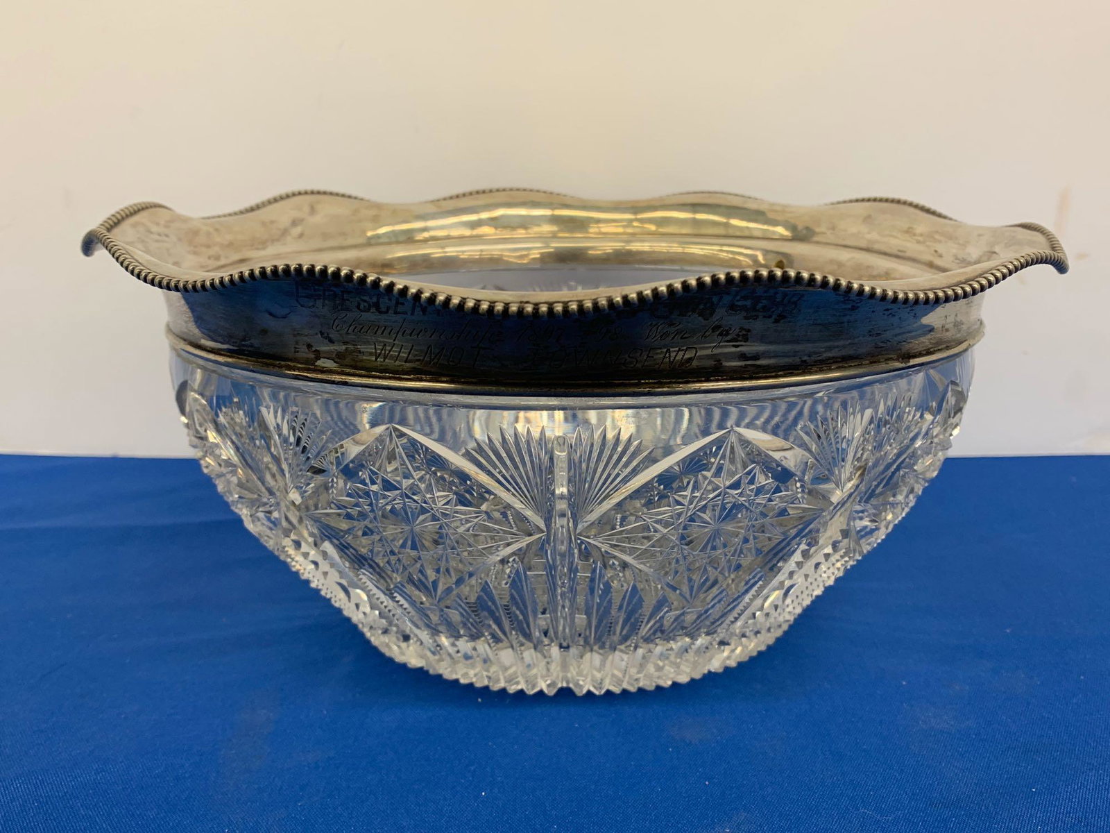 American Cut Glass & Sterling Trophy Bowl: An American brilliant period cut-glass bowl with scalloped sterling silver rim, inscribed as a presentation trophy from the "Crescent Athletic Gun Club / Championship 1897 - 98. Won by / Wilmot Townse