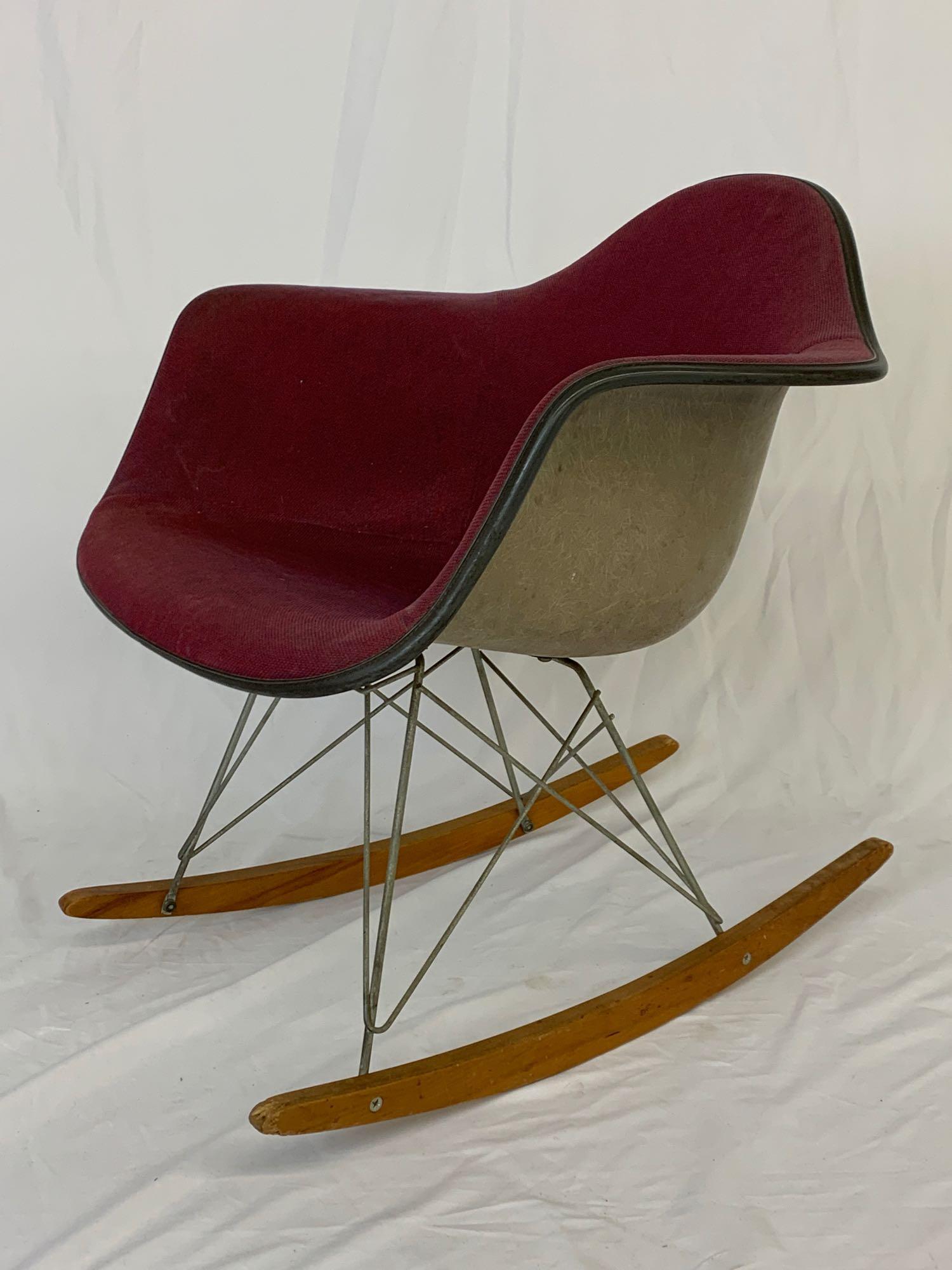 Eames/Herman Miller RAR Rocking Chair: A Charles & Ray Eames for Herman Miller RAR rocking chair. Grey shell with red and blue upholstered cover on a steel frame and wooden runners. Raised label. 27in tall x 25in wide x 27in deep.
