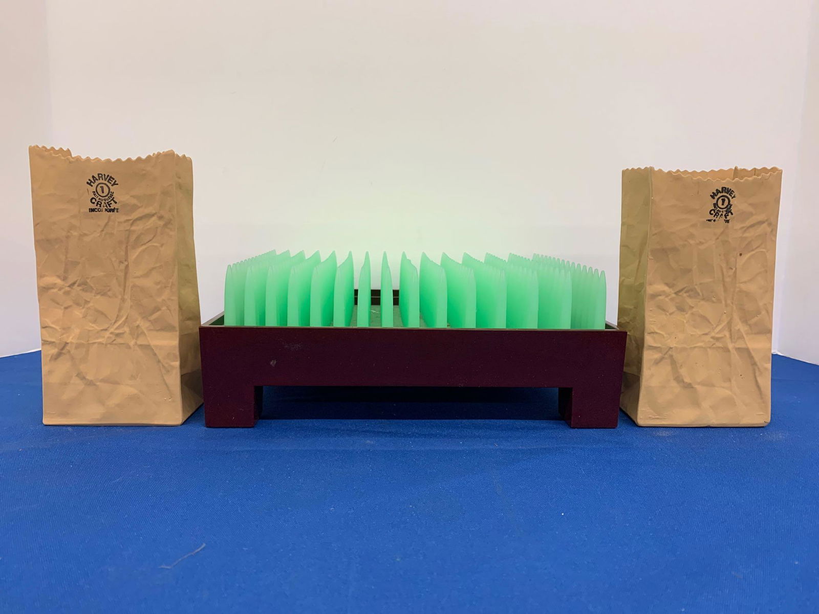 Three-pc. Modern Design Decor Grouping: A three-piece modern design decor grouping to include a Philippe Starck Liberte letter holder for Alessi, and two Harvey Craft ceramic paper bags. Letter holder: 3-1/2in tall x 9in wide x 7in deep.