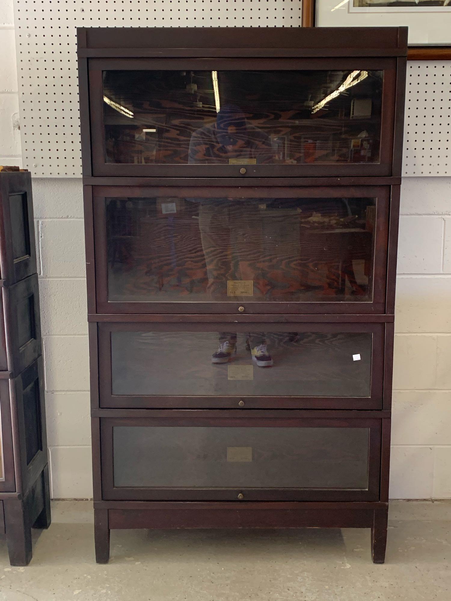 Globe Wernicke Mahogany Sectional Bookcase: A Globe Wernicke mahogany sectional barrister bookcase with four stacking compartments: two pattern 809 sections, one 813, and one 811. 61in tall x 34-1/2in wide x 11-1/2in deep.