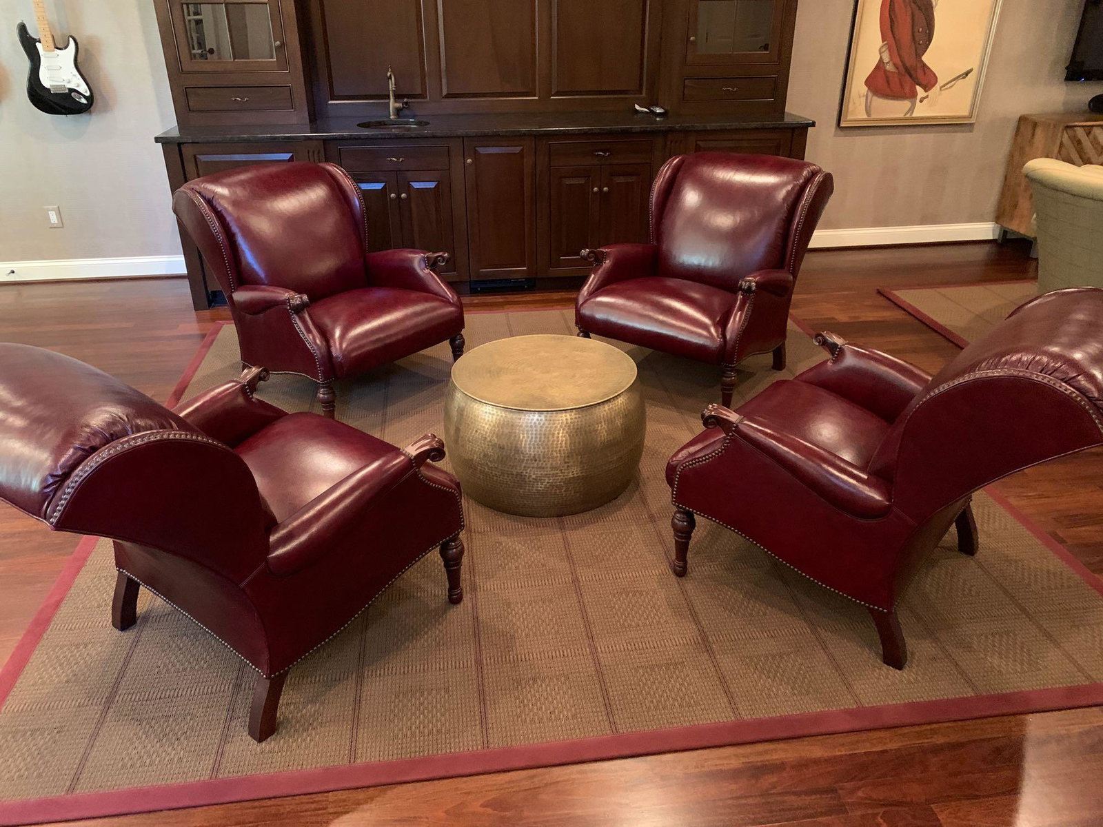 Pr. Stickley Leather Regency-style Lounge Chairs: A pair of Stickley Fine Upholstery Collection lounge chairs with burgundy leather upholstery, having brass-tacked trim and mahogany legs. Each is 35in tall x 30in wide x 36in deep.
