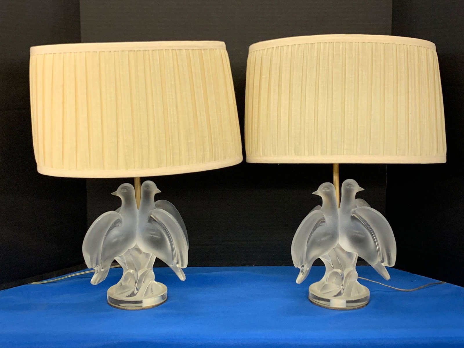 Pair of Lalique Turtle Dove Table Lamps: A pair of Lalique Ariane turtle dove table lamps, each with frosted glass double dove forms and gilt bronze two light supports. Signed. Height to top of shades: 18in. Bases: 8-3/4in tall.