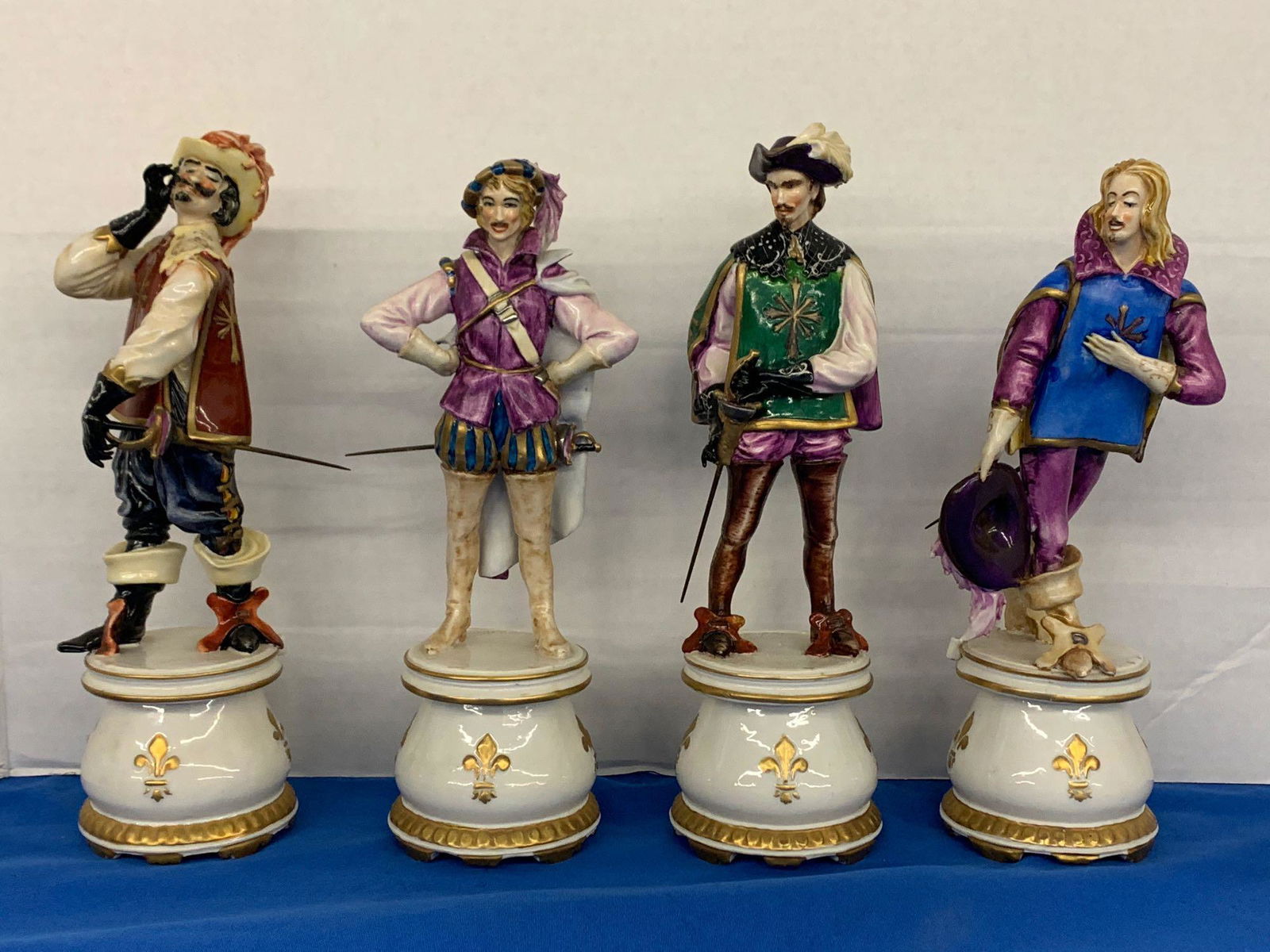 Four Italian Porcelain Musketeer Figures: A grouping of four Italian porcelain musketeer figures by Guido Cacciapuoti. All signed on bases. Tallest: 11in.
