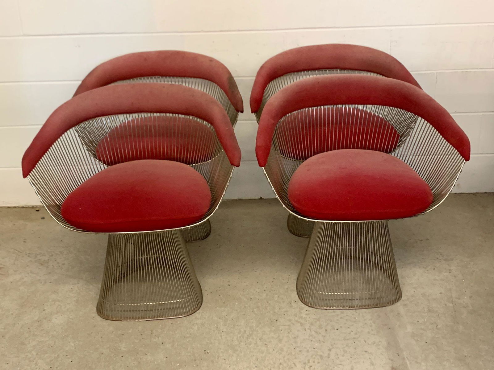 Four Warren Platner Dining Chairs: A set of four Warren Platner steel rod dining chairs with red upholstered seats and backs. Knoll. Not marked. Each is 28-1/2in tall x 27in wide x 20in deep.