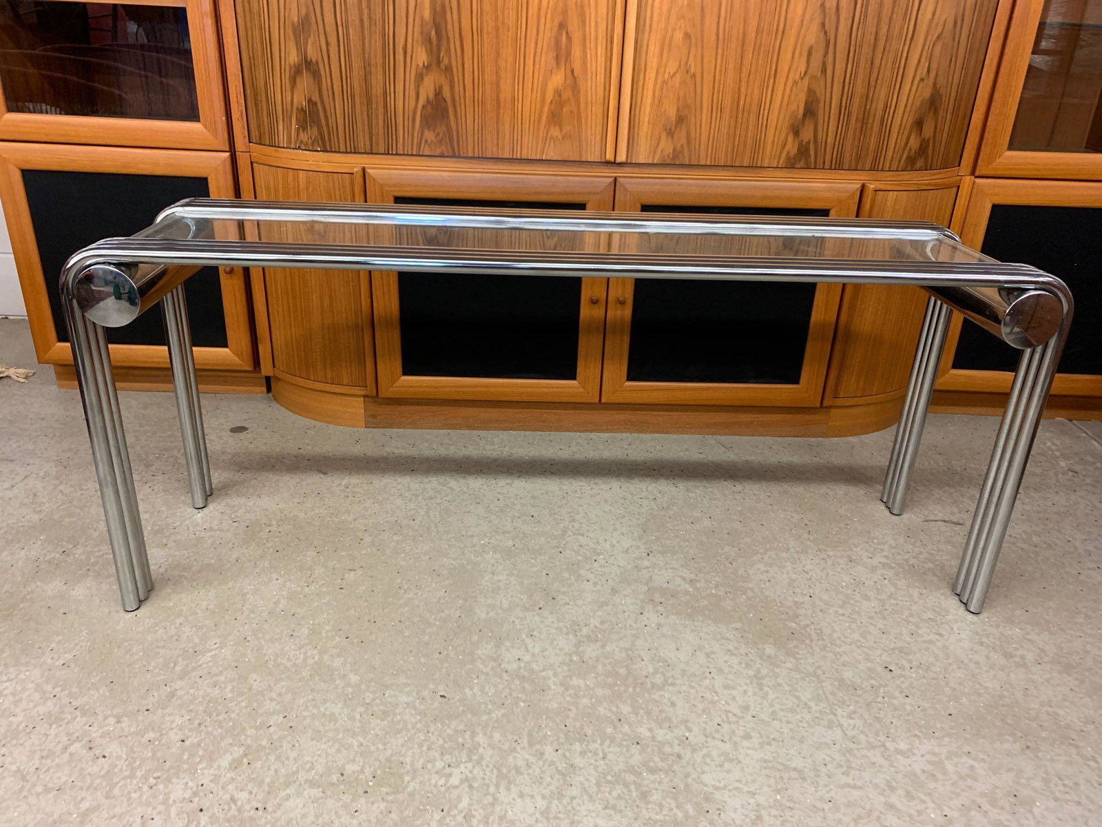 1970s Modern Tubular Chrome & Glass Console Table: A 1970s modern console or sofa table with tubular chrome frame. 24in tall x 58in long x 16in wide.