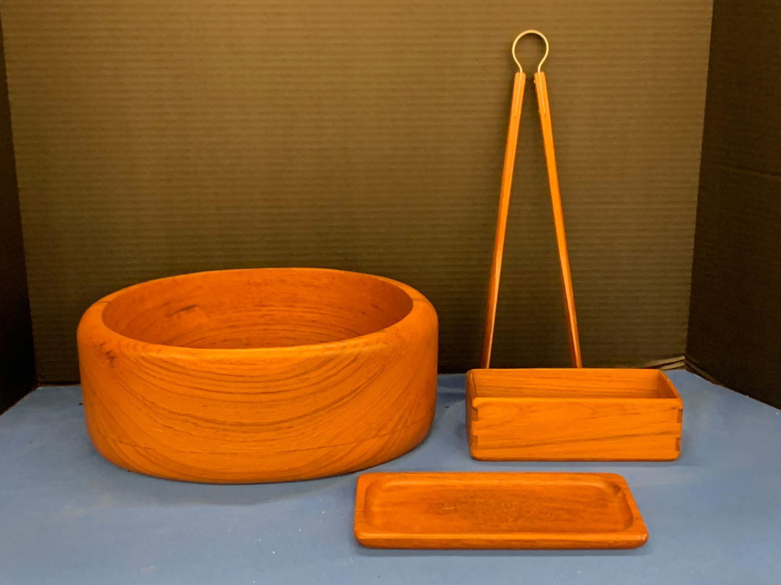 Four-piece Sowe Scandinavian Teak Grouping: A four-piece grouping of teak tablewares by Sowe, Sweden, to include an oval bowl, tongs, rectangular box, and tray. All stamped. Bowl: 4-3/4in tall x 11-1/4in wide.