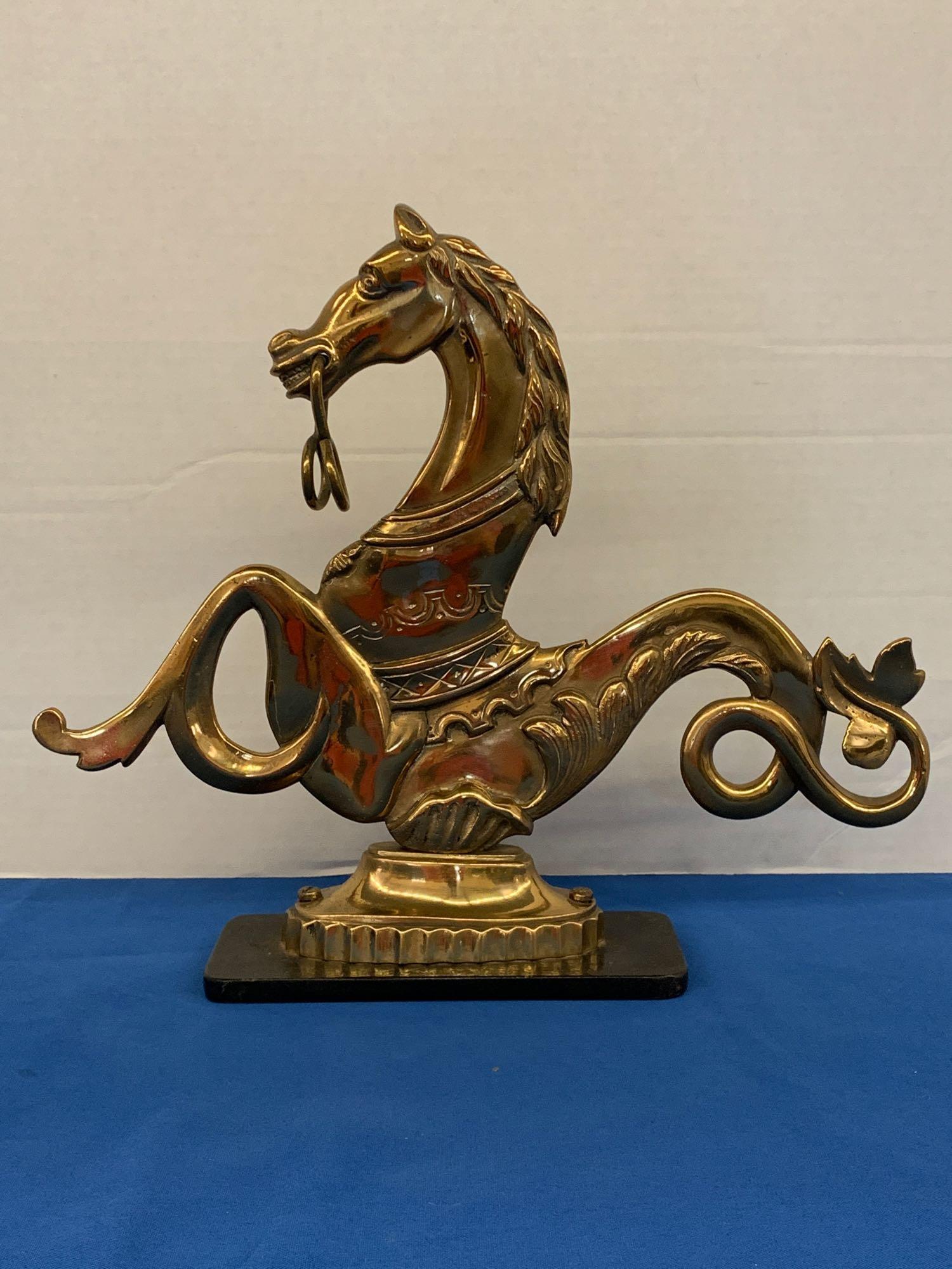 Brass Venetian Figural Doorstop: A Venetian cast-brass figural gondola mooring mount or door stop depicting a seahorse, mounted on a cast iron base. 11-1/2in tall x 13-1/4in wide.
