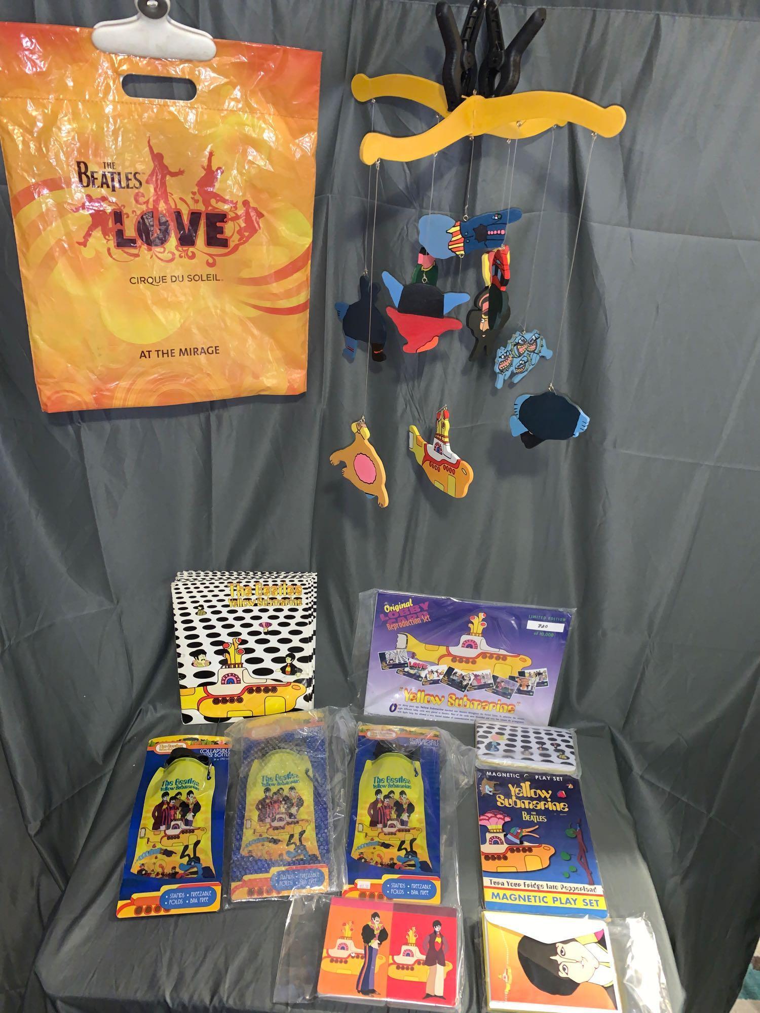 Grouping of Beatles Yellow Submarine Memorabilia: A grouping of Beatles "Yellow Submarine" memorabilia including a handmade mobile, a Beatles-related shipping bag, seven Yellow Submarine folders (six are in fair to poor condition, one is very good), 