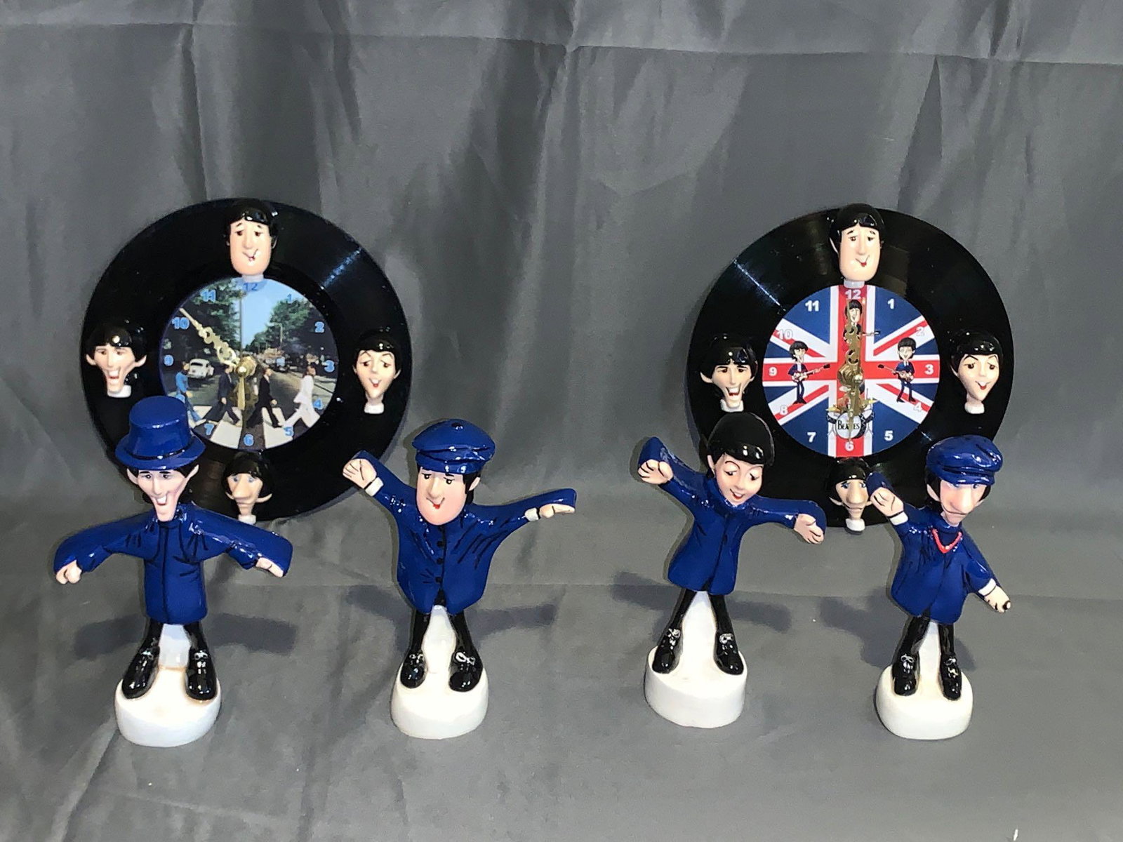 Set of Four Beatles Help! Figures & Two Clocks: A set of four Beatles "Help!" figures (apx 5.5in tall), and two vinyl Beatles Clocks made from 45rpm records and composition Beatle faces (7in diameter).