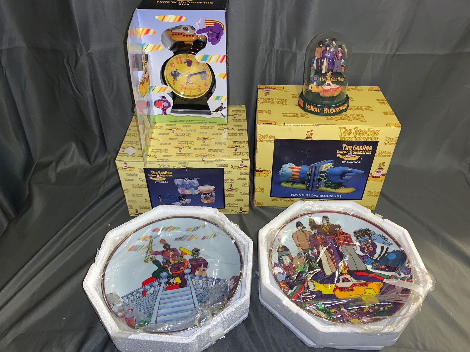 Yellow Submarine Memorabilia: A grouping of Yellow Submarine memorabilia including Franklin Mint domed music box, two collector's plates, three-piece bath set, pair of bookends and a clock, all have original boxes and packing.
