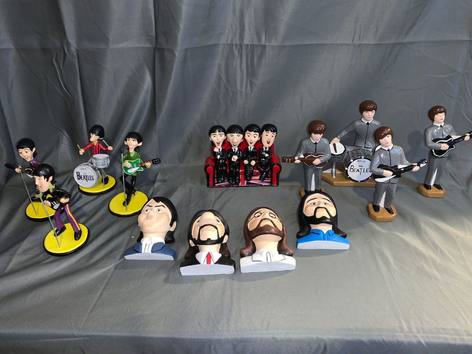 Four Beatles Figurine Groupings: A lot of four Beatles figurine groupings including a set of four by Holland Mold in gray suits, a set of four Bossuns-style heads, a set of four cartoon figures and a Mexican creation four cartoon Bea