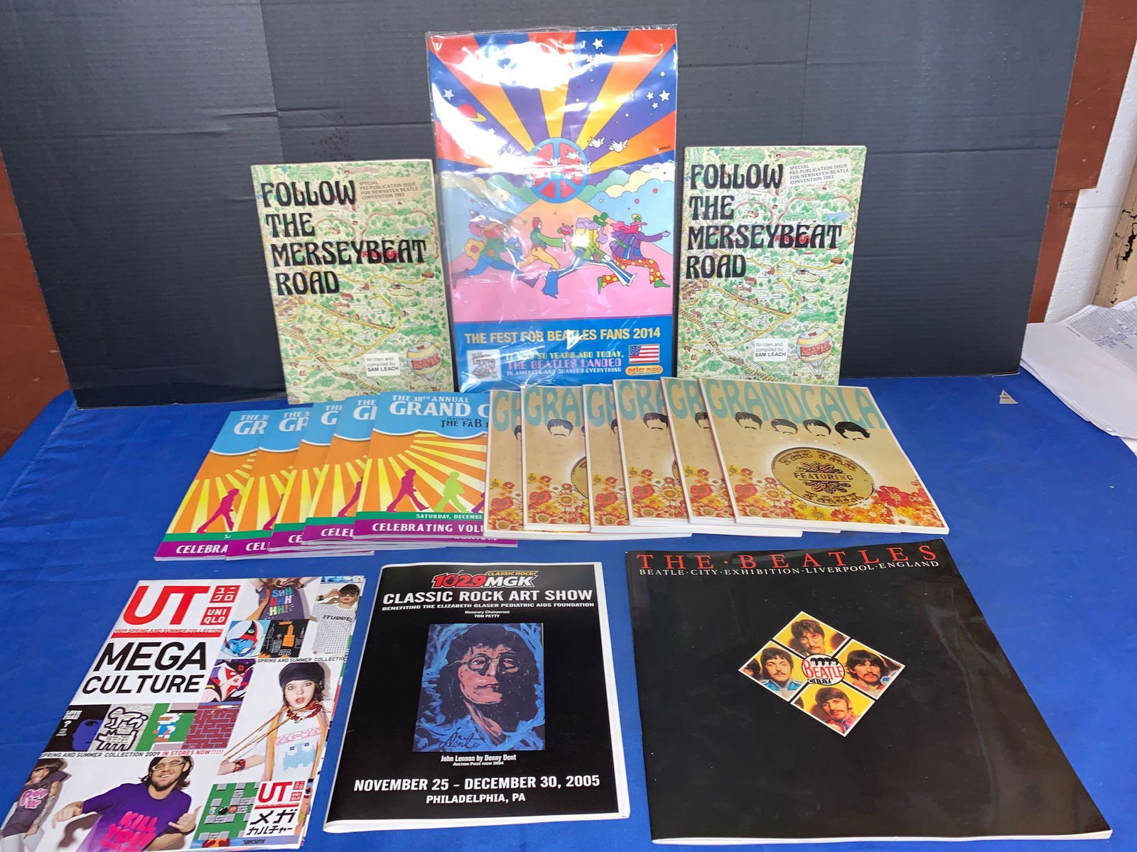 Grouping of Beatle Fest and Liverpool Memorabilia: A grouping of Beatle Fest and Liverpool memorabilia, including a Peter Max 2014 Fest for Beatles Fans poster, two Follow the Merseybeat Road both signed by Sam Leach, Beatle City Exhibition program an
