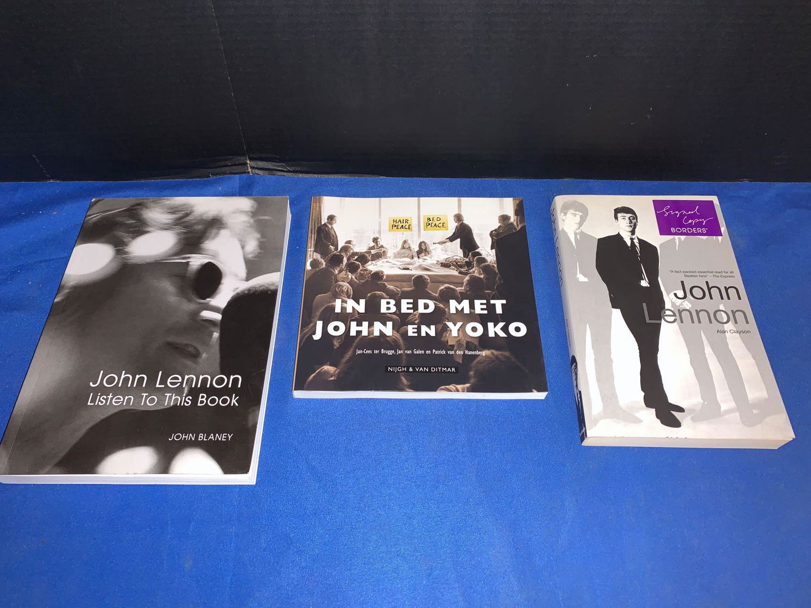 Three Signed John Lennon Books: A lot of three John Lennon books signed by the authors, including "John Lennon Listen to This Book" by John Blaney; "In Bed Met John en Yoko" by Jan-Cees ter Brugge, Jan Van Galen, and Patrick Van den