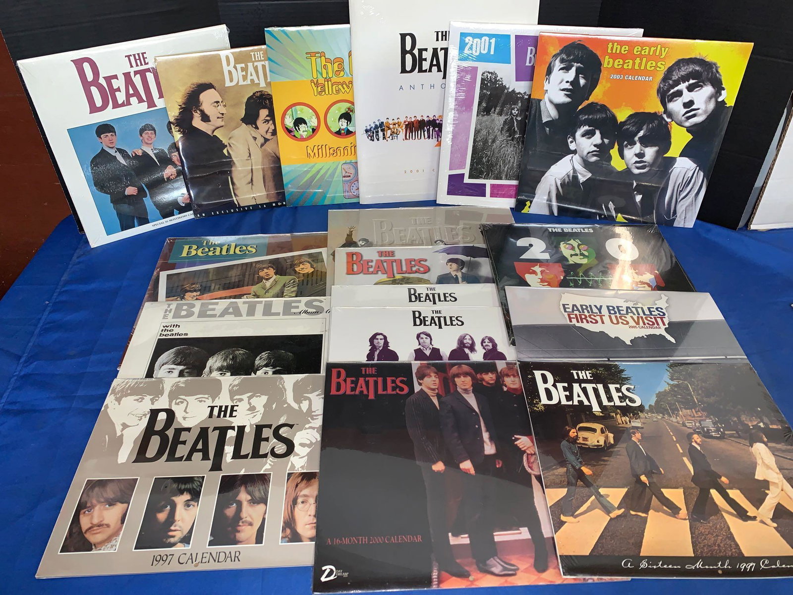 17 Unopened Beatles Calendars: A lot of 17 unopened Beatles calendars from 1989 to 2005, non-inclusive. This grouping does contain the millennium Yellow Submarine, the Anthology and the Abbey Road calendars.