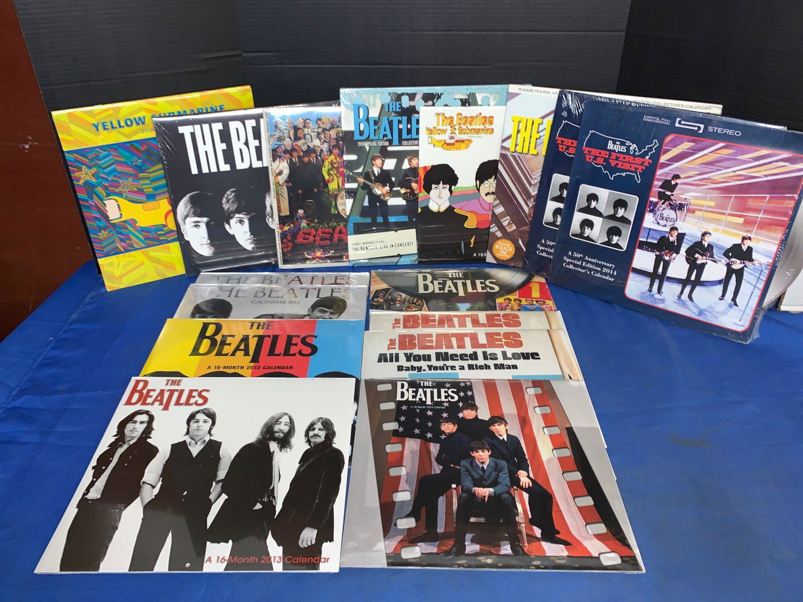 16 Unopened Beatles Calendars: A lot of 16 unopened Beatles calendars ranging from 2006 to 2014 non-inclusive. This grouping has album and 45 covers like two Yellow Submarine, a Sgt. Peppers, a Please Please Me, two Second Albums a