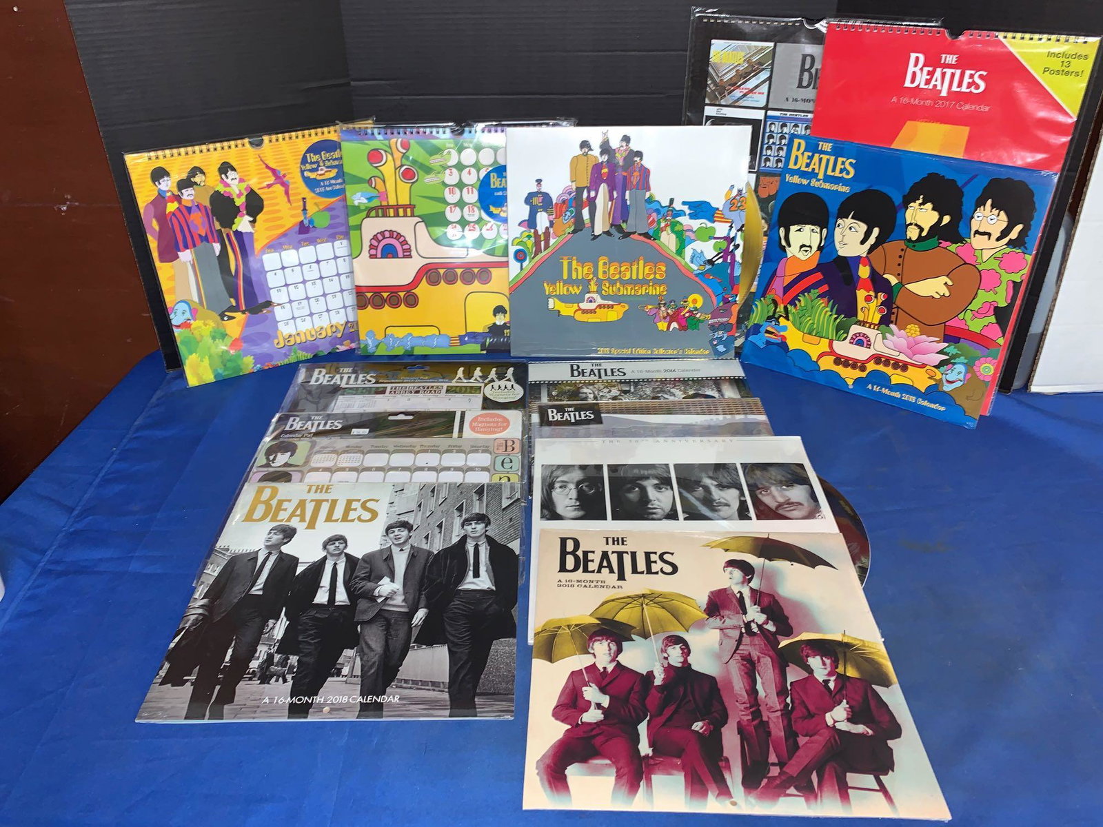 13 Unopened Beatles Calendars: A lot of 13 unopened Beatles calendars, including four Yellow Submarine and a White Album calendar.