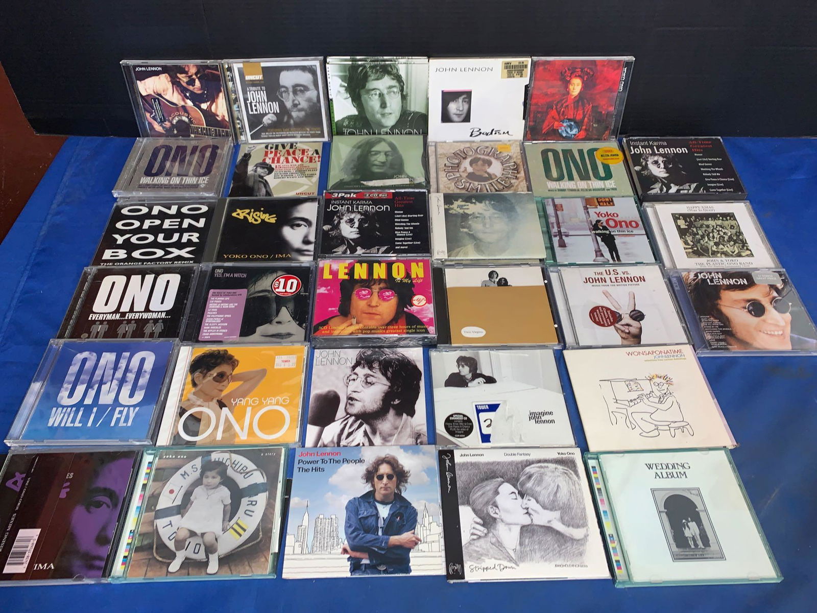 38 John Lennon and/or Yoko Ono CDs: A lot of 38 John Lennon and/or Yoko Ono CDs, some of them have never been opened and are still sealed.
