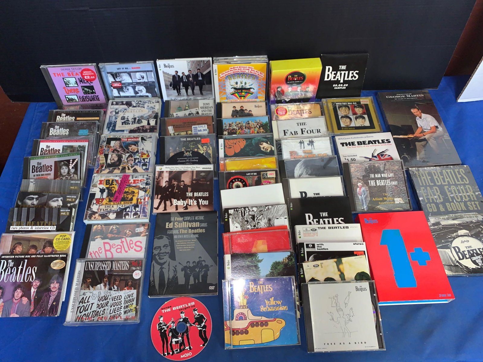63 Beatles CDs, DVDs, and Box Sets: A lot of 63 Beatles CDs, DVDs, and Box Sets, some still sealed, never been opened including George Martin box set, Beatles interview discs, a Russian Beatles CD, and more.
