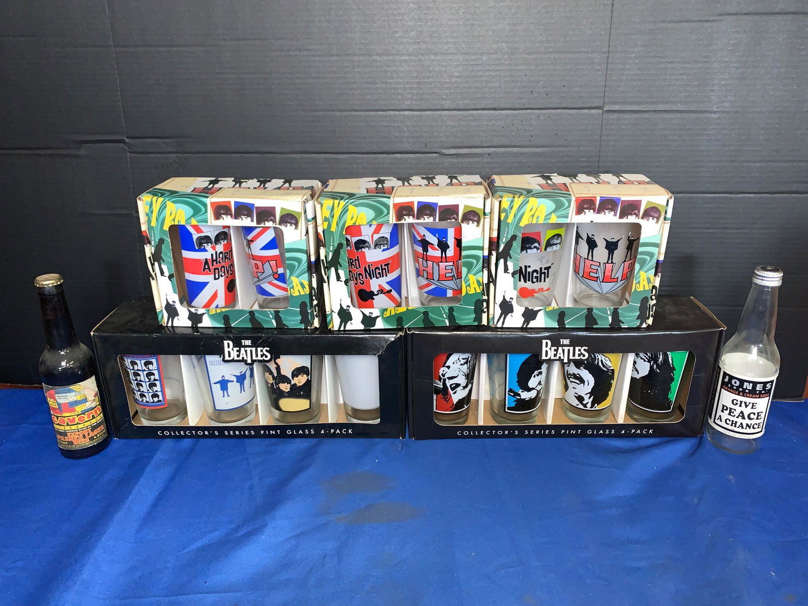 Beatles Pint Glasses and Bottles: A lot of Beatles pint glasses (in original boxes) and bottles (one bottle with a Cavern Club Liverpool label).