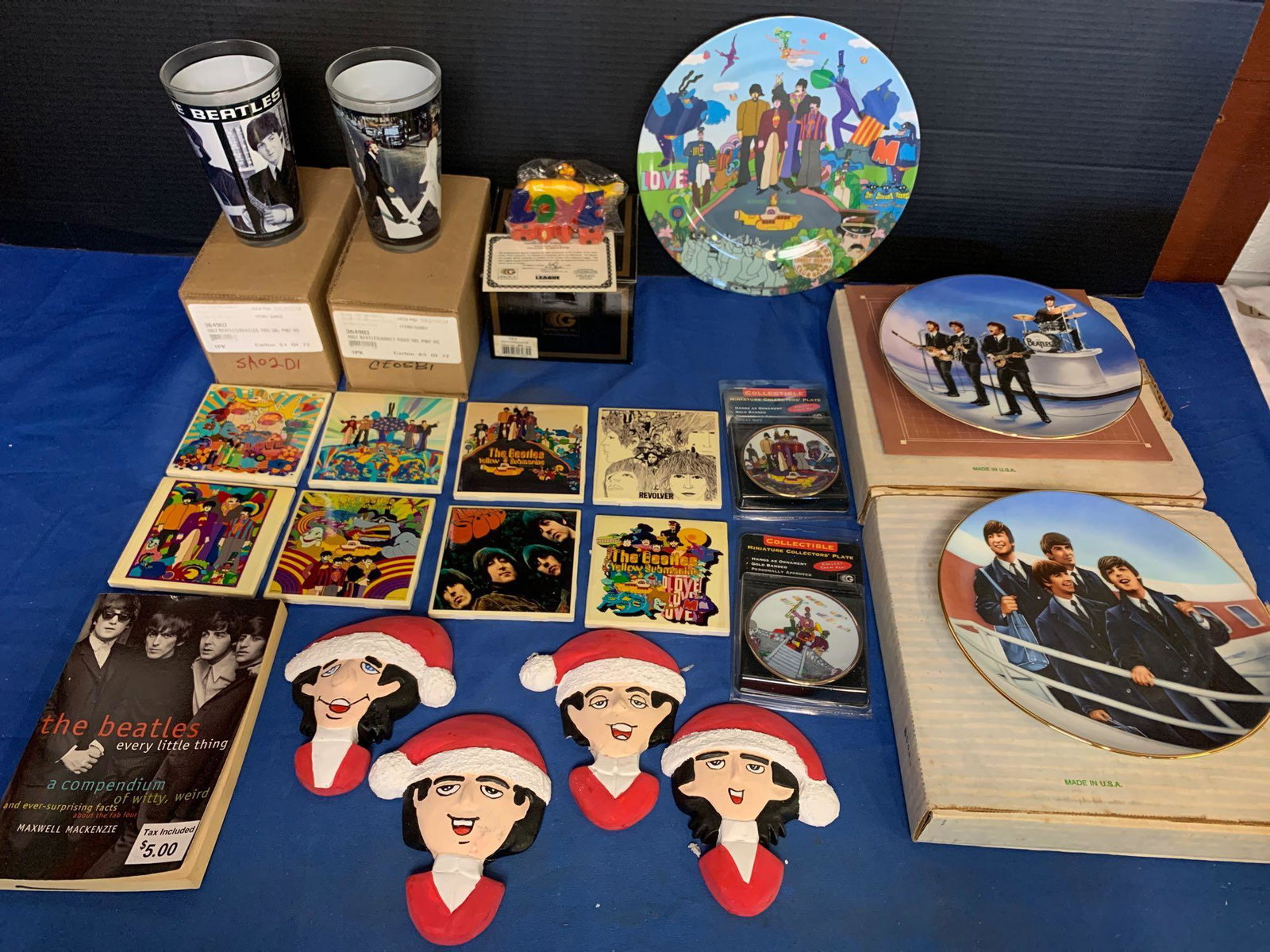 Beatles Grouping: Tiles, Plates, Glasses, etc.: A grouping of Beatles memorabilia including eight ceramic tiles, two pint glasses, two collector's plates, two miniature collector's plates, a set of Christmas wall hangings, a book, a Melamine plate 