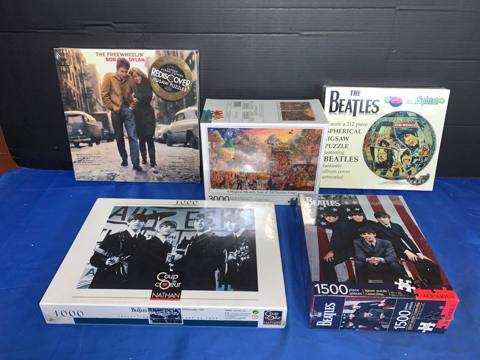 Five Puzzles: Beatles & Bob Dylan: A lot of five puzzles, to include four Beatles, and one Bob Dylan. One is a 3-D spherical puzzle.