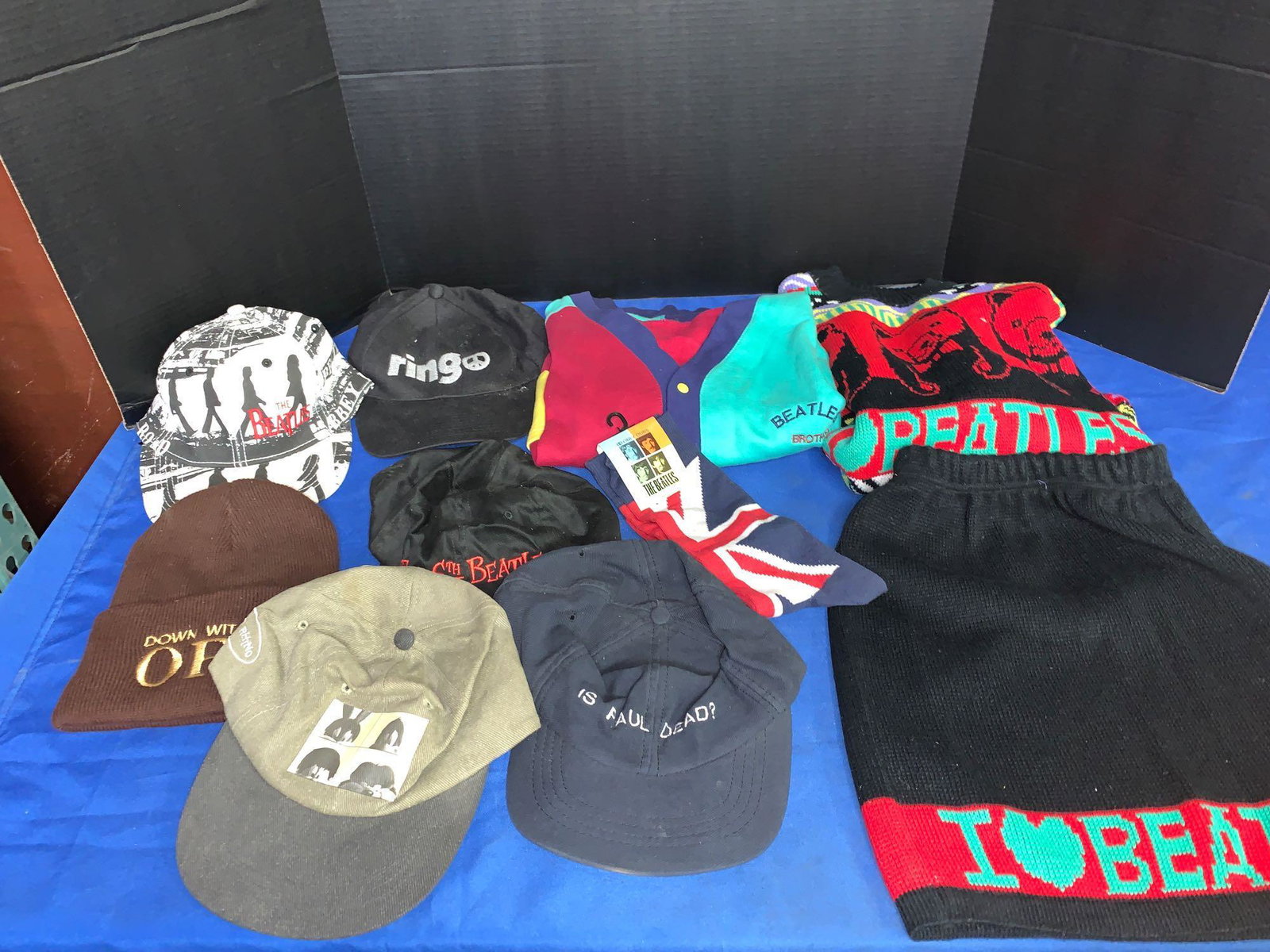 Grouping of Beatles Clothing: A grouping of Beatles clothing, including six hats, a Beatles Brothers shirt, a Beatles Sweater and skirt, and Beatles socks.