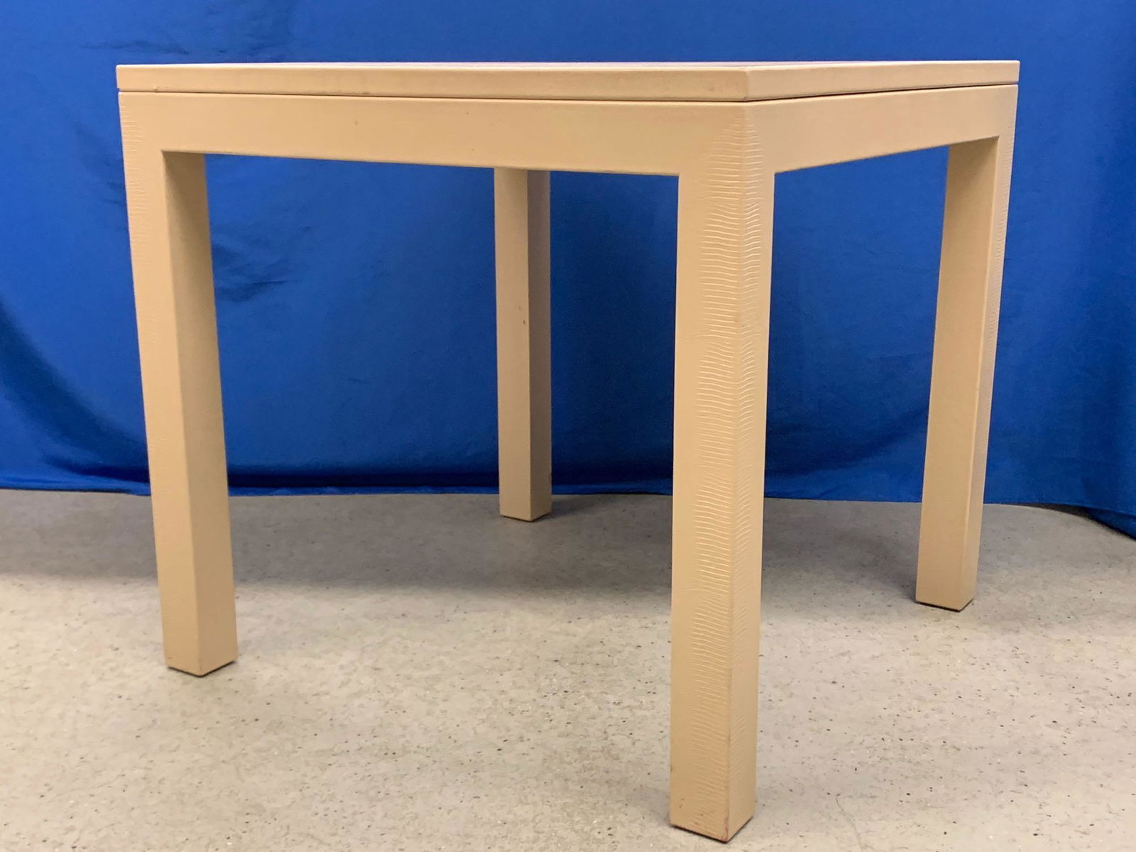 Attrib. Karl Springer Game Table: A faux-snakeskin covered game table attributed to Karl Springer, having a removable top with a checkerboard underside and backgammon inset, complete with playing pieces. Unmarked. 30in tall x 32in wid