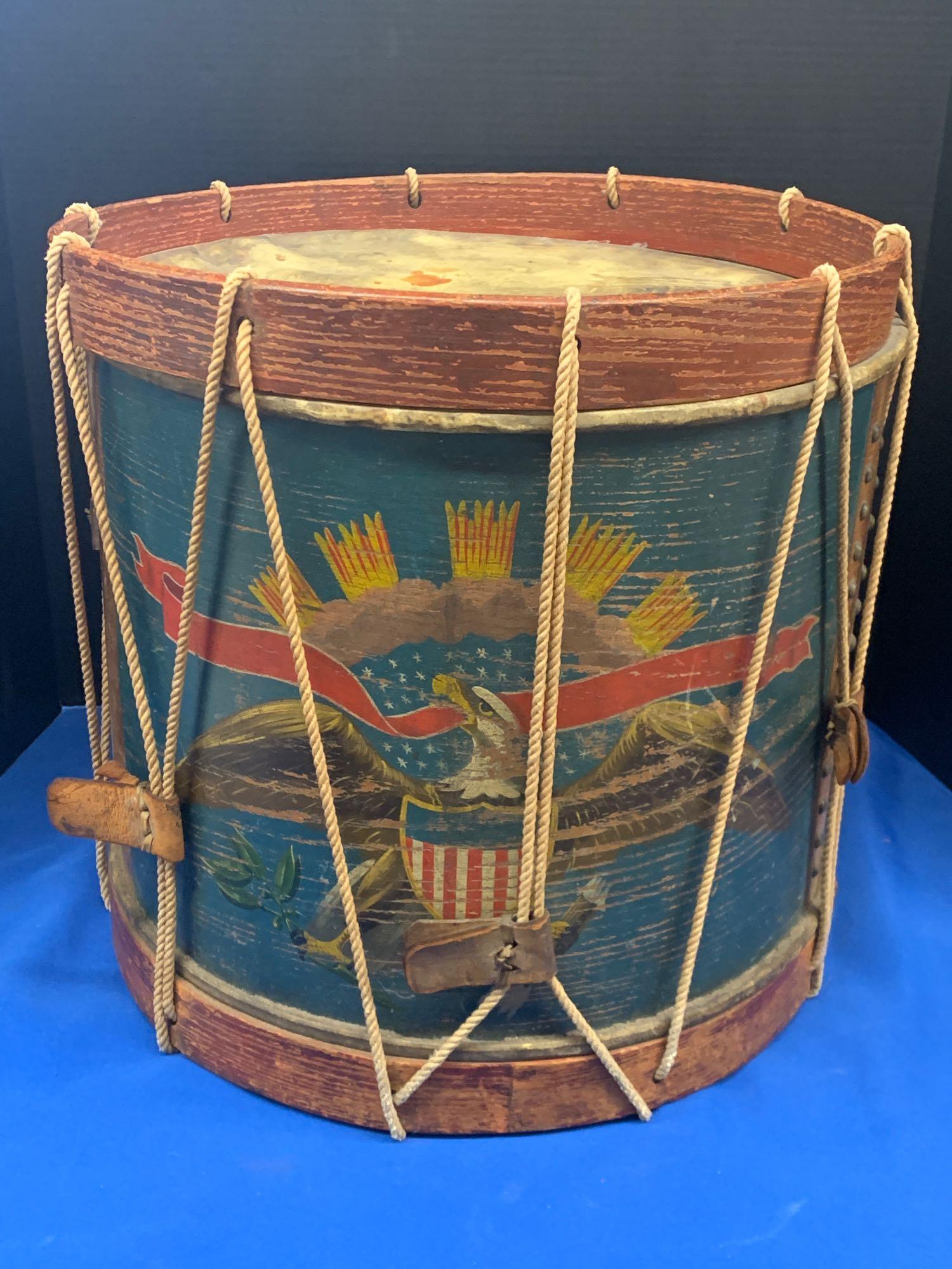 Labeled Horstmann Paint-Decorated Civil War Drum: A rope tension Civil War-era drum by Horstmann and Bros., Philadelphia, having a large paint-decorated eagle with shield and banner and brass-tacked design around vent hole. Label on interior states "