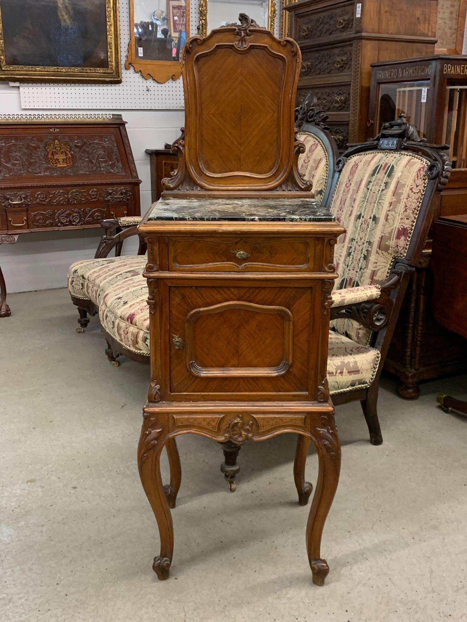 French Louis XV-style Commode: A French Louis XV-style carved commode having a carved panel back over a case with green marble inset over a small drawer and cabinet. 52-1/2in tall x 18in wide x 15in deep.