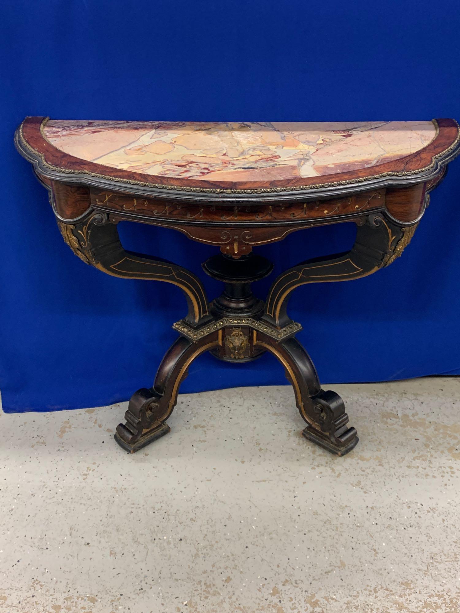 Victorian Pier Console Table: A Victorian console pier table having an inset marble top, rosewood frame with gilt adornment, and gilt metal mounts. 28in tall x 36in wide x 16-1/2in deep.
