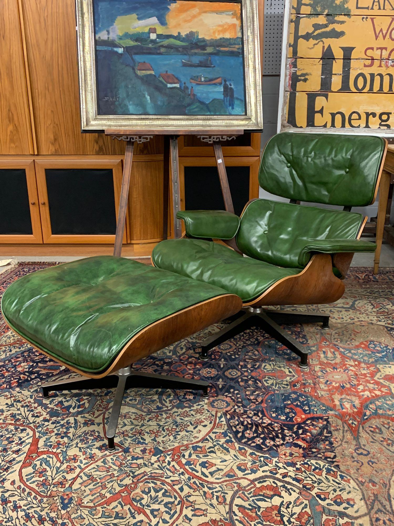 Charles & Ray Eames Lounge Chair and Ottoman: A Charles & Ray Eames rosewood lounge chair (No. 670) and ottoman (No. 671) with green leather down-filled upholstery. Herman Miller tags on both pieces. Chair with mark. 33in tall x 33in wide x 33in