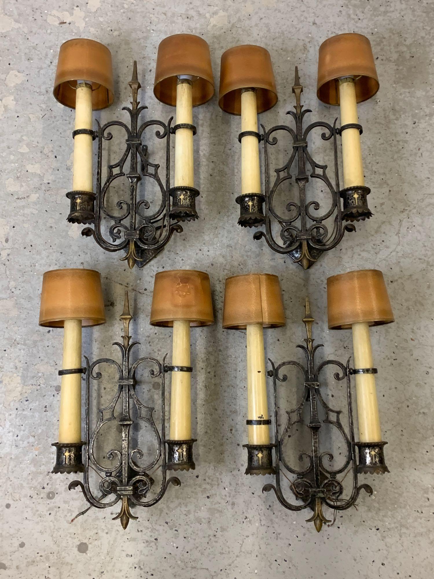 Set of Four Patinated Metal Wall Sconces: A set of four patinated metal wall sconces, each with scrolled forms and two lights with paper shades. Each is 18 in x 10-1/2 in. Provenance: From a Karcher and Livingston-designed Haverford, PA home,
